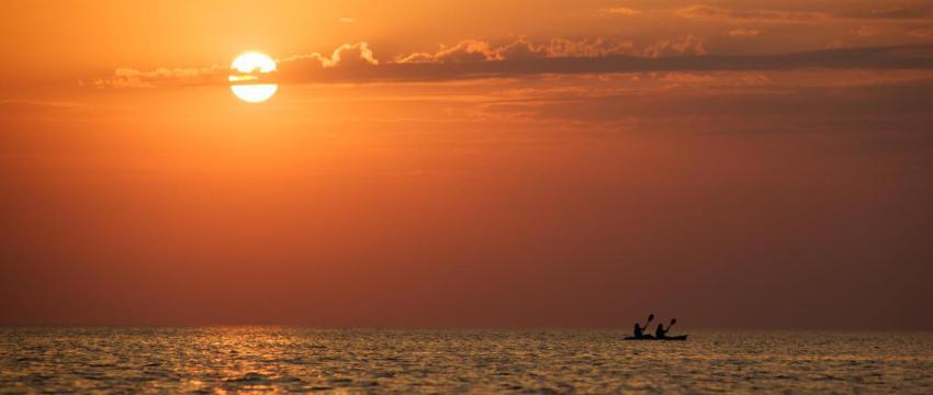 Seascape of still sea surface men on boat and gol 2023 11 27 04 55 04 utc