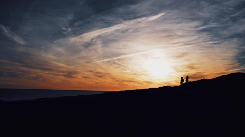 Wide shot of silhouettes of two people walking on 2023 11 27 04 51 31 utc