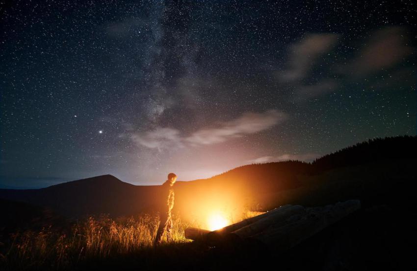 Man iswalking in mountains and lighting bonfire 2023 11 27 05 17 29 utc