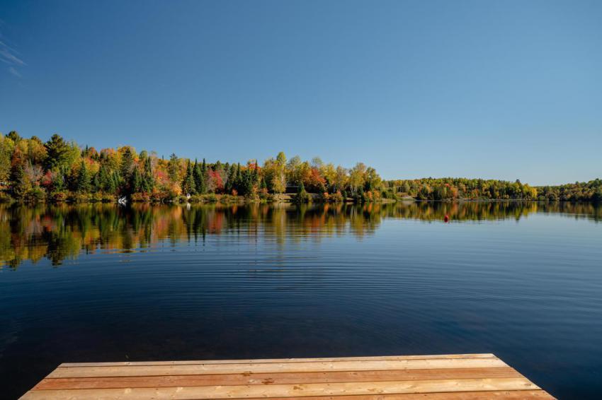 Dock and the autumn trees reflecting on lac fairbu 2023 11 27 05 00 36 utc