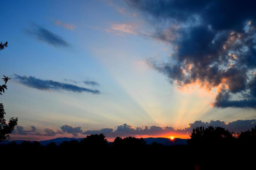 Dramatic sunset with sunbeams and clouds over moun 2023 11 27 05 26 44 utc
