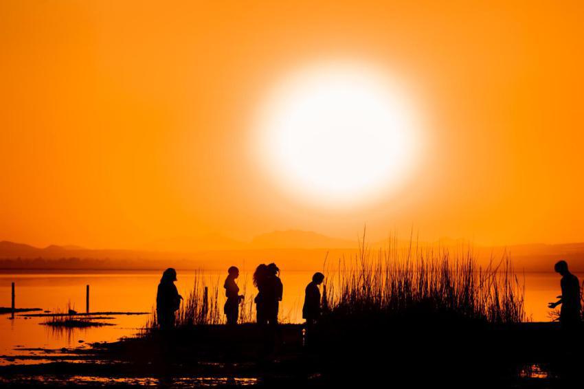 People at the orange sunset by the lake 2024 10 24 03 06 34 utc