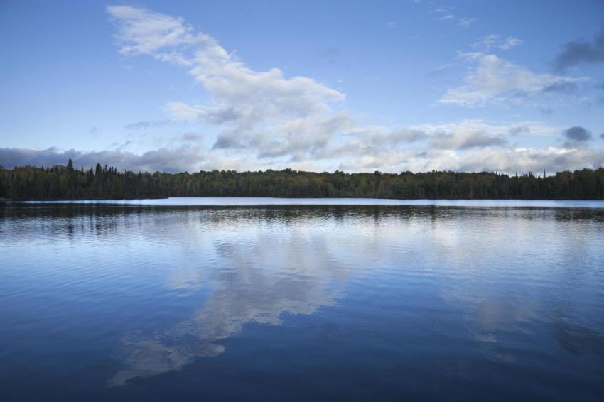 Blue sky and clouds over calm lake at dusk in nort 2023 11 27 04 59 22 utc
