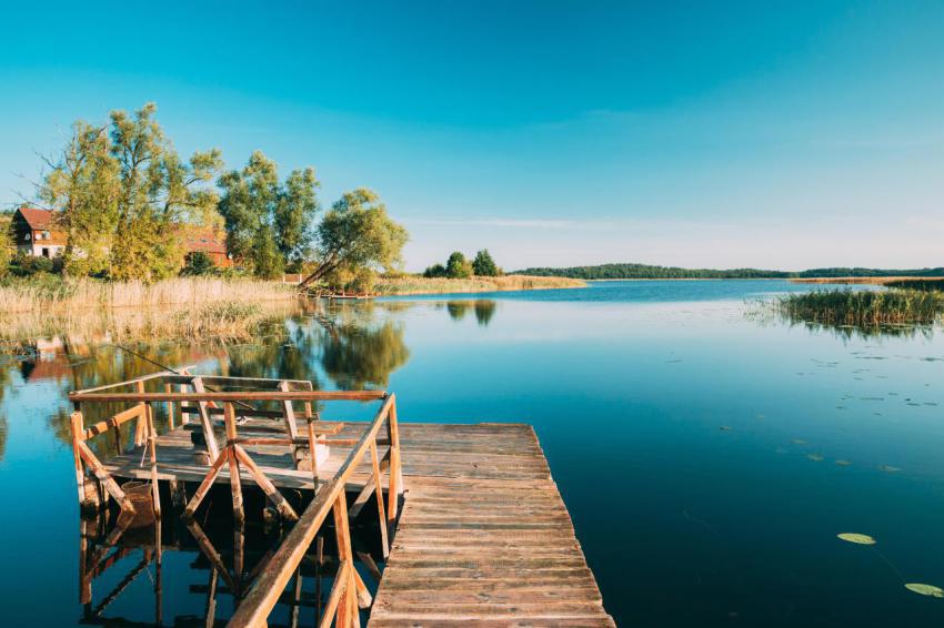 Old wooden fishing pier near summer lake or river 2023 11 27 05 05 15 utc