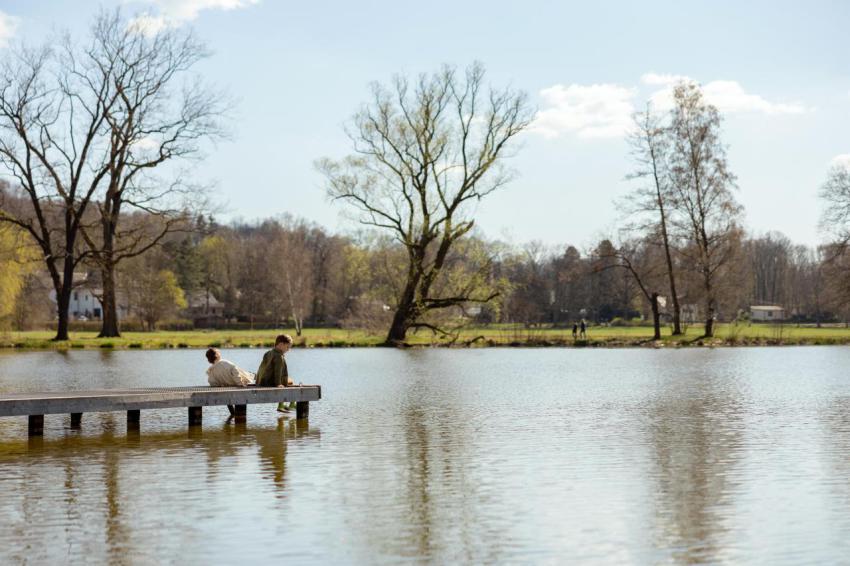 Two boys sitting together outdoors near to the la 2024 12 07 13 44 22 utc