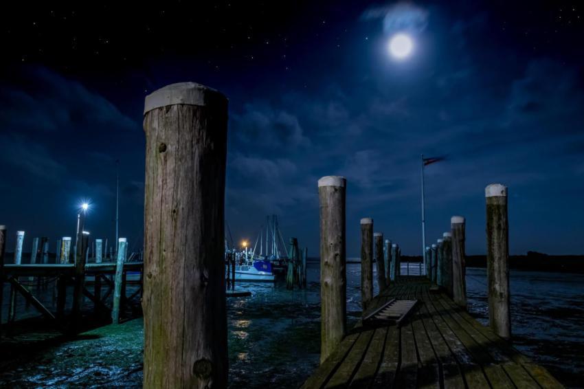View of the wooden post on a dock with a bright sh 2023 11 27 04 51 29 utc