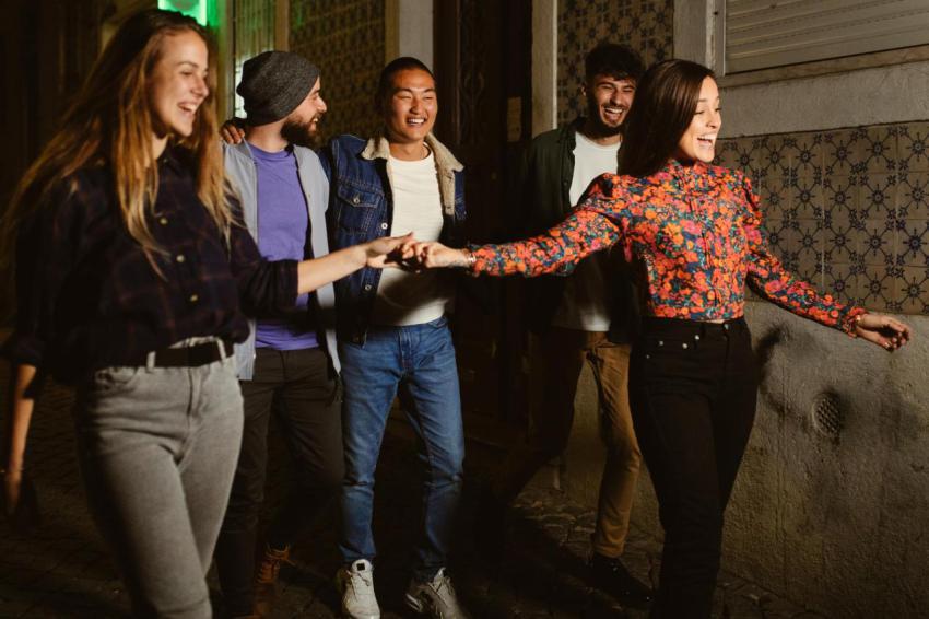 Group of mixed race friends walking at night in th 2024 10 18 05 31 48 utc