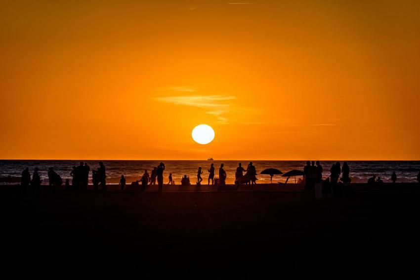 Silhouette of a beach full of people under the clo 2023 11 27 05 18 07 utc