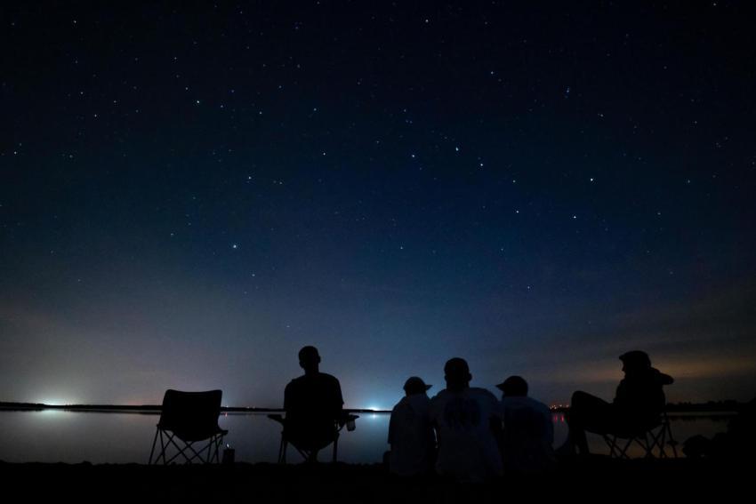 Group of people sitting on the coast of river with 2023 11 27 05 23 14 utc
