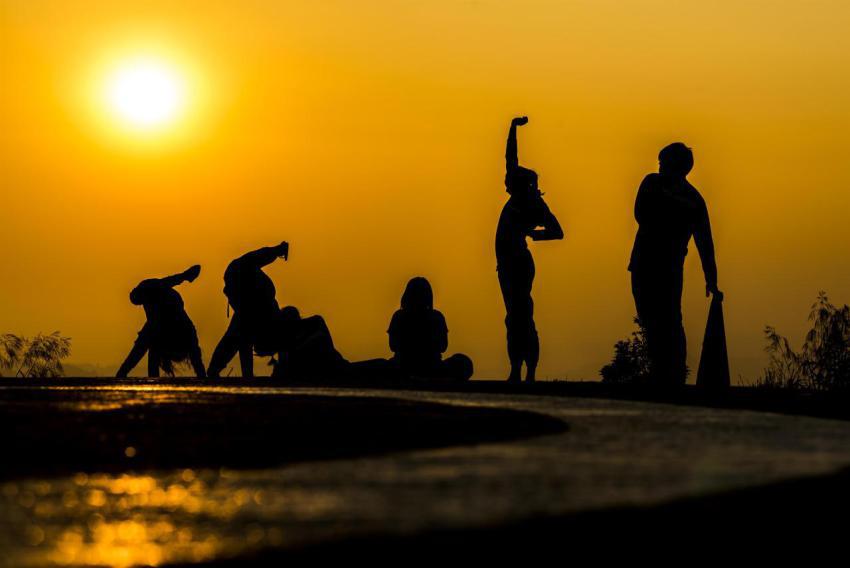 Silhouette of people group practicing yoga on the 2023 11 27 05 00 37 utc
