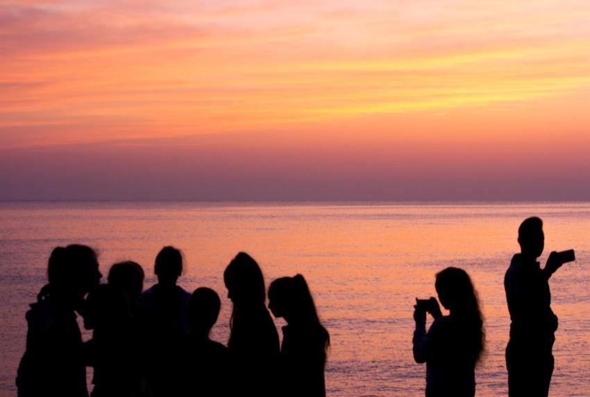 Silhouettes of group of people on the beach waitin 2023 11 27 05 05 14 utc