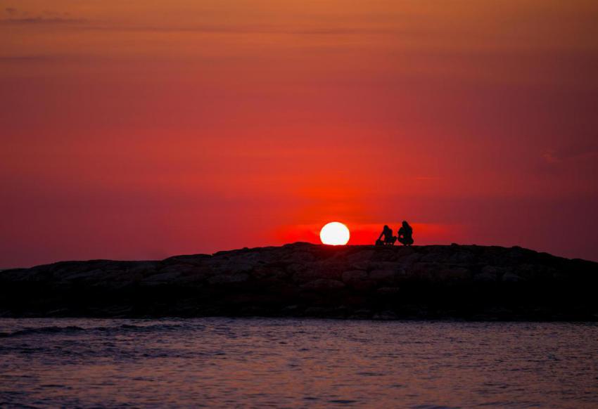 Silhouettes of people at sunset on the beach of ku 2023 11 27 05 23 18 utc
