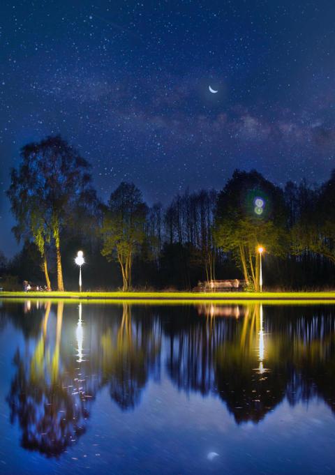 Beautiful shot of a lake with park lights reflecti 2023 11 27 04 49 15 utc