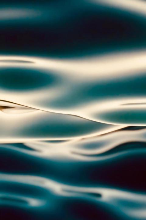 Macro shot of blue water waves reflecting lights 2023 11 27 04 50 14 utc